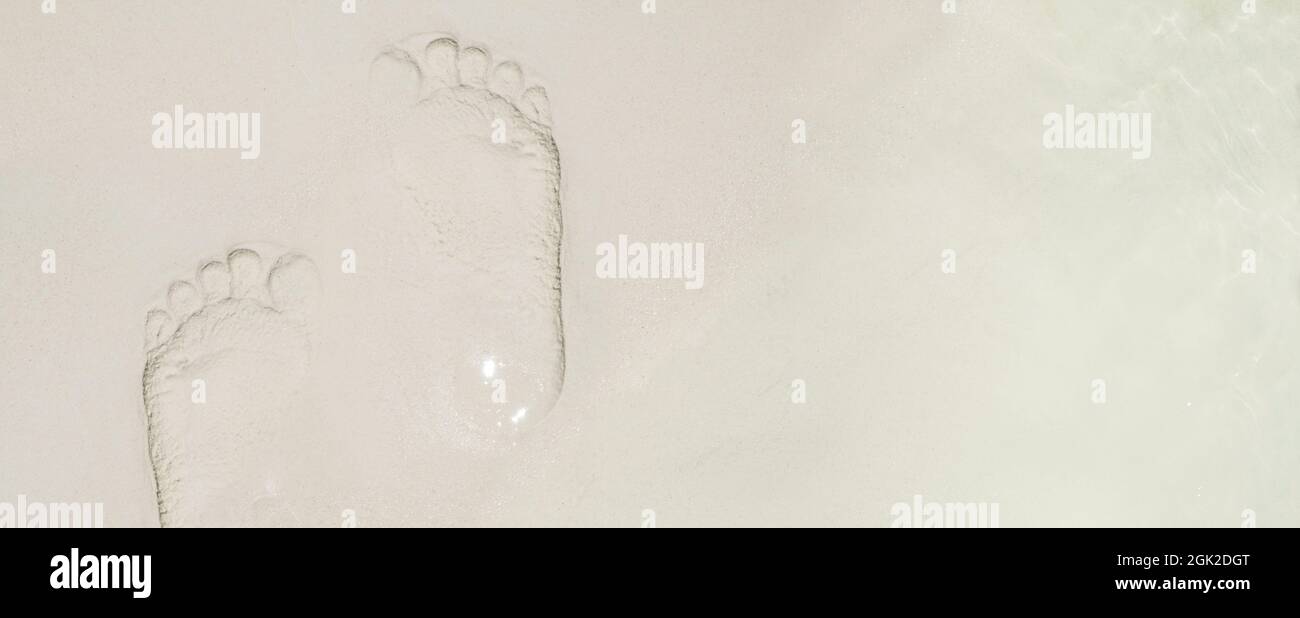 top view footprint on sand at sea beach in summer day.vacation banner background Stock Photo