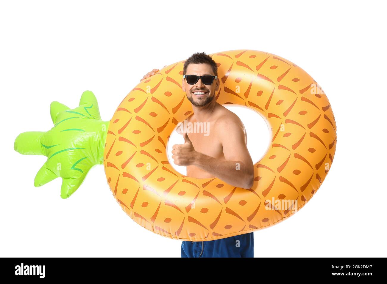 Young man with inflatable ring showing thumb-up on white background ...