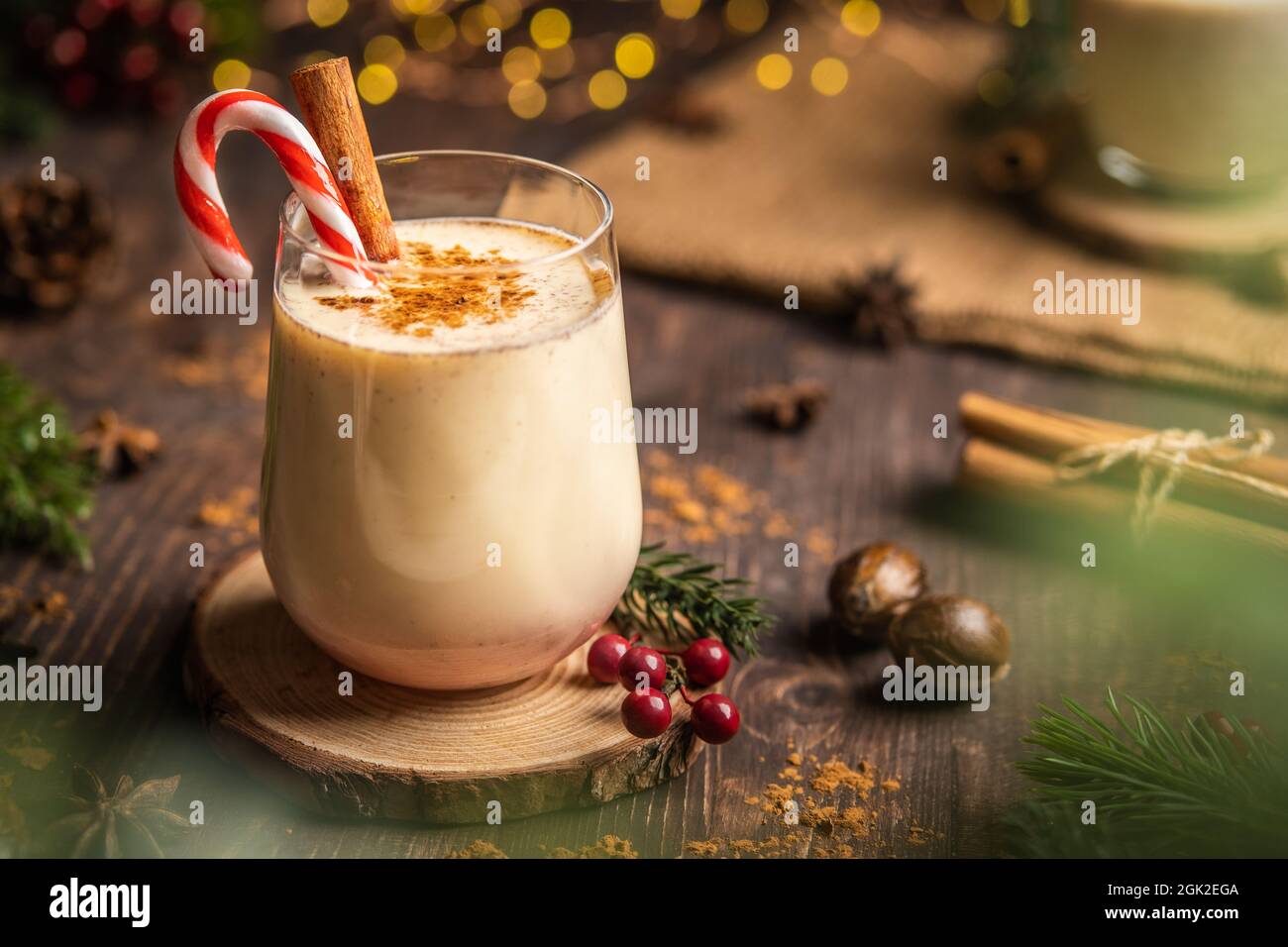 Eggnog with spicy cinnamon.Christmas and winter holidays,Cozy cocktail with cinnamon and candy cane,Traditional Christmas drink with grated nutmeg and Stock Photo