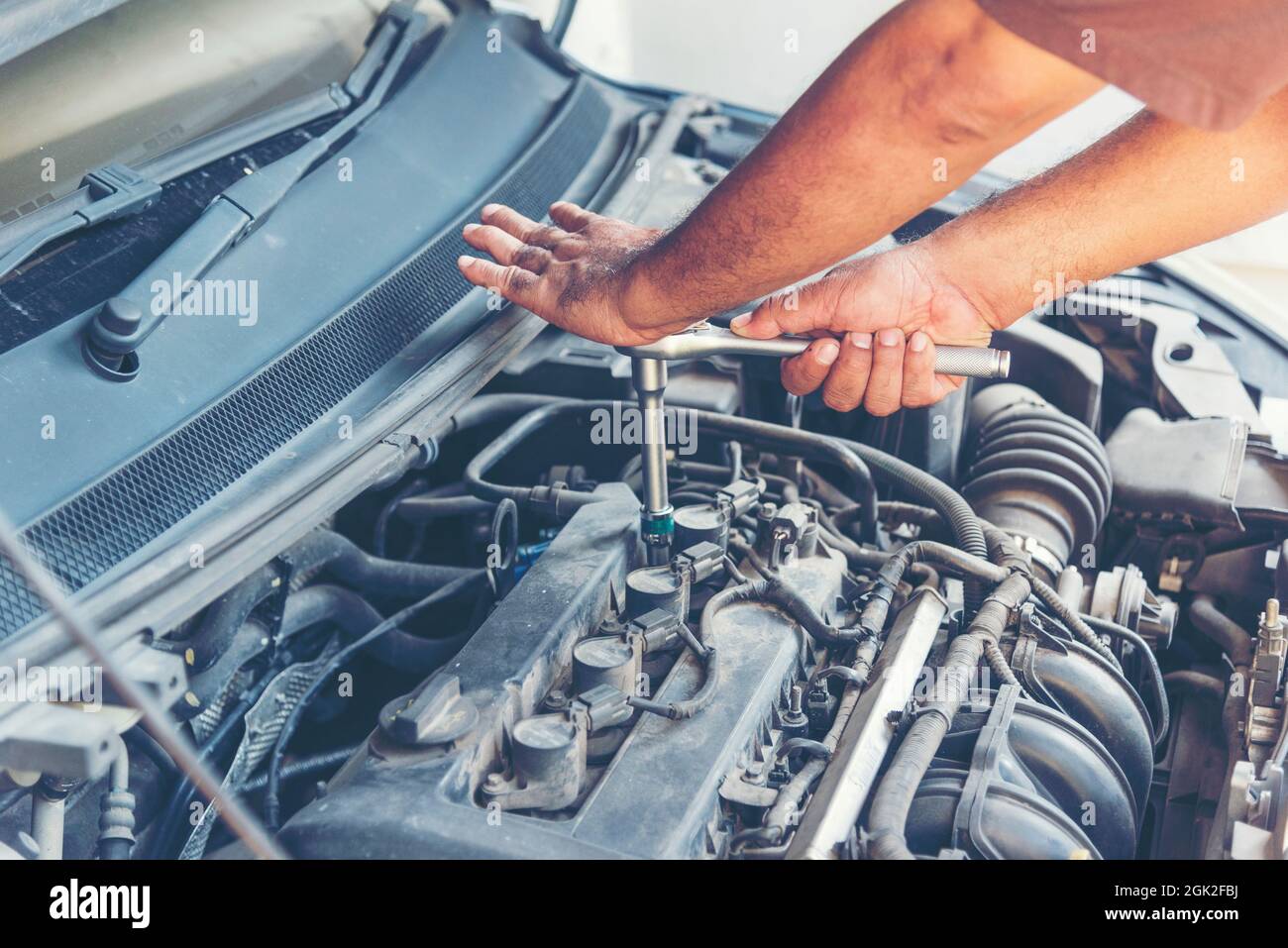 Mechanic Car Service in automobile garage auto car and vehicles service mechanical engineering. Automobile mechanic hands car repairs automotive techn Stock Photo