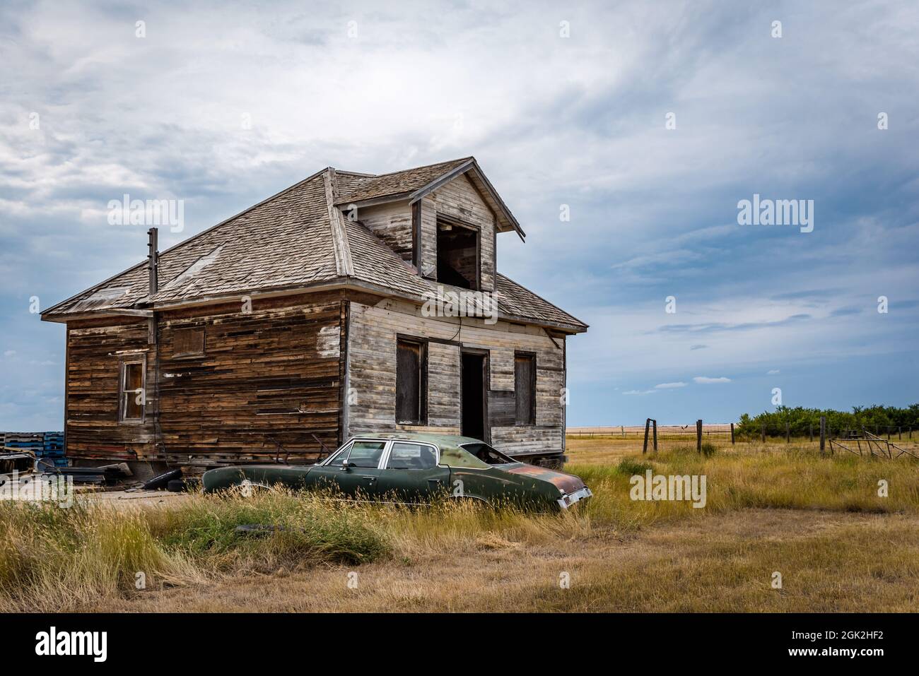 An old, abandoned home and classic car in the ghost town of Robsart