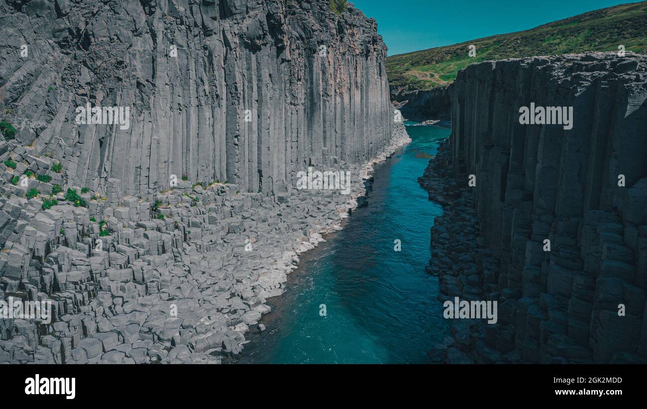 Aerial drone panorama of studlagil canyon in Iceland, picturesque valley with basalt columns standing high on a warm summer day. Stock Photo
