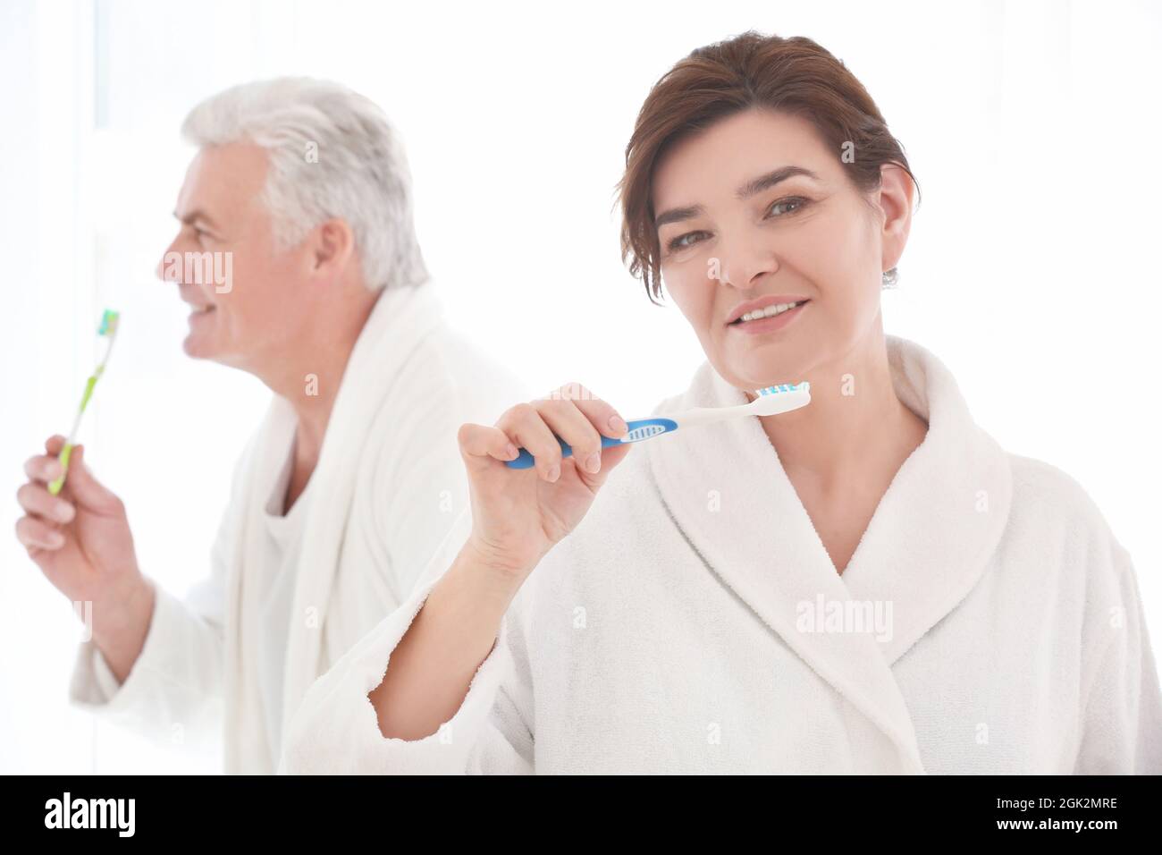 Senior woman and her husband cleaning teeth at home Stock Photo Alamy