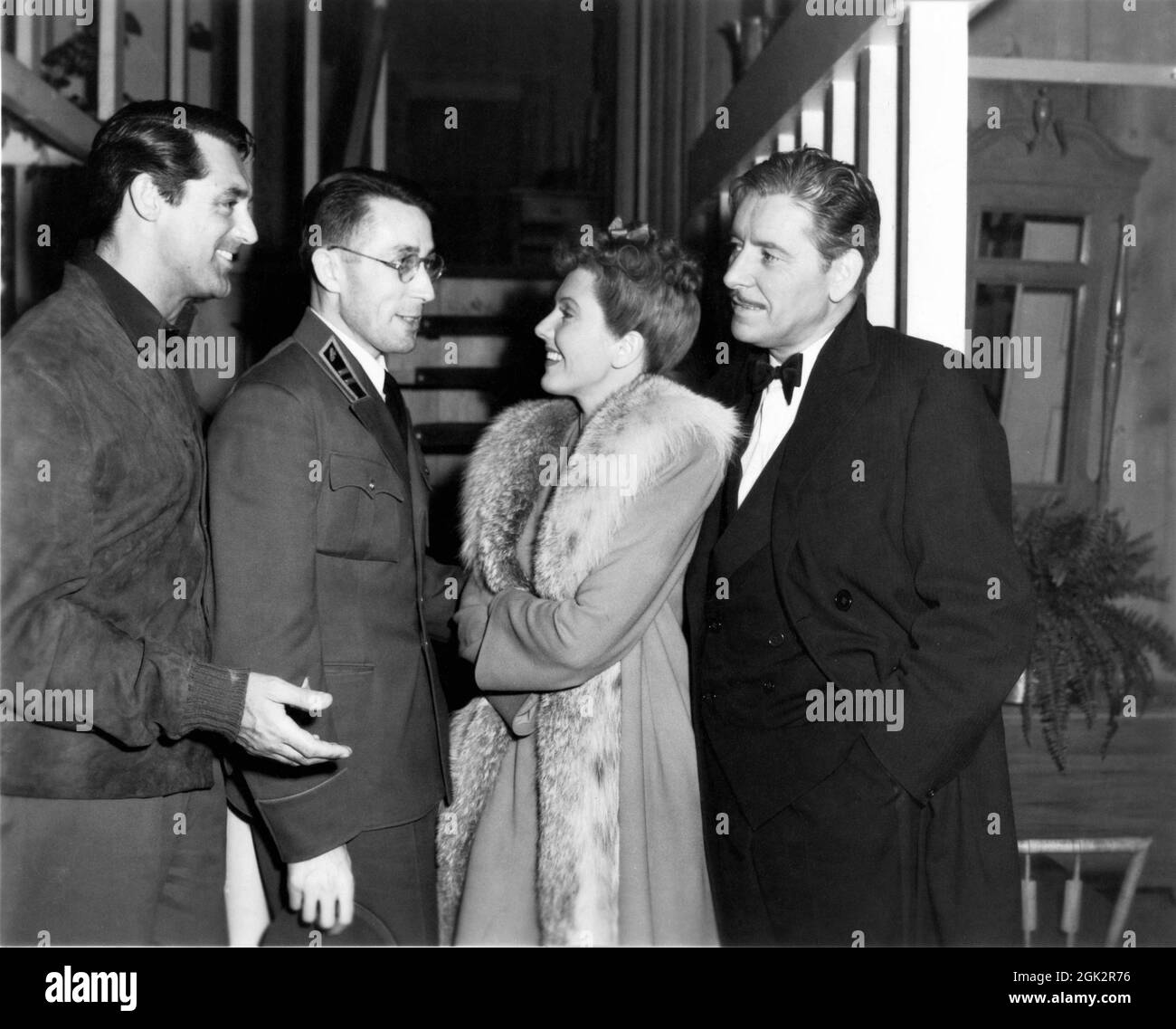 CARY GRANT set visitor CHARLES LANE JEAN ARTHUR and RONALD COLMAN on set candid during filming of THE TALK OF THE TOWN 1942 director GEORGE STEVENS story Sidney Harmon adaptation Dale Van Every screenplay Irwin Shaw and Sidney Buchman music Frederick Hollander Columbia Pictures Stock Photo