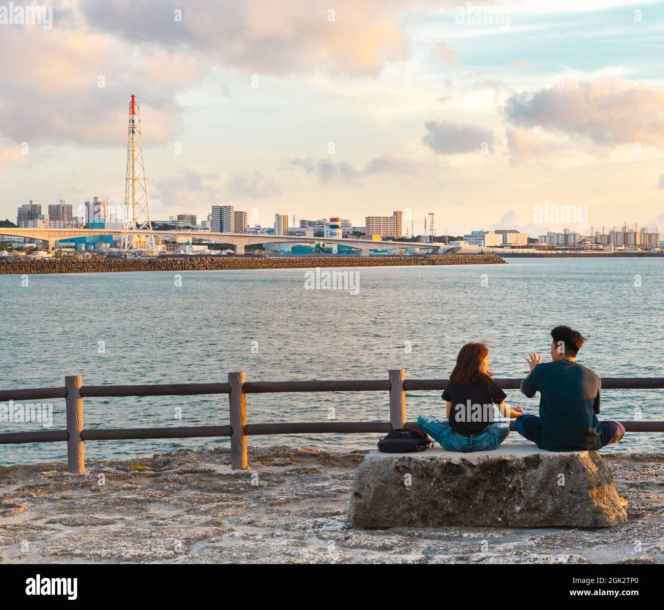 Young couple talking and having fun during sunset hour Stock Photo