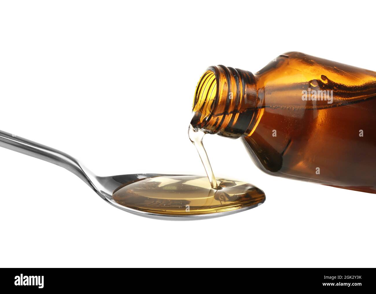 Pouring cough syrup into spoon on white background Stock Photo Alamy