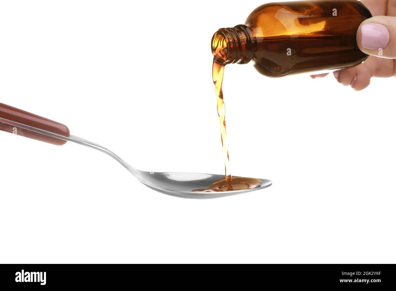 Pouring cough syrup into spoon on white background Stock Photo Alamy