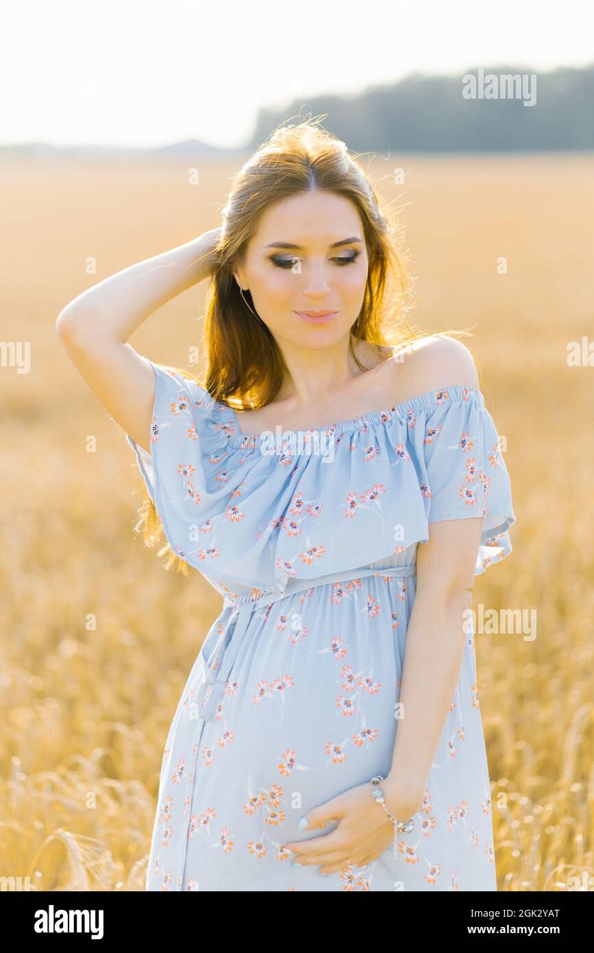 Pregnant woman in blue dress hi-res stock photography and images - Alamy