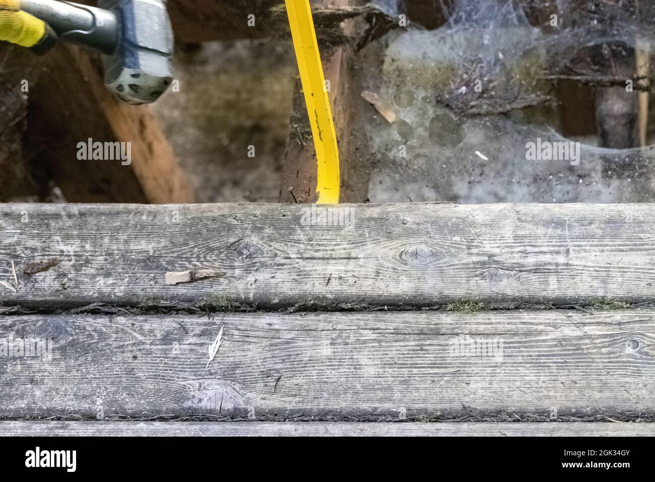 Prying Up yellow crowbar and mallet prying up boards Stock Photo - Alamy