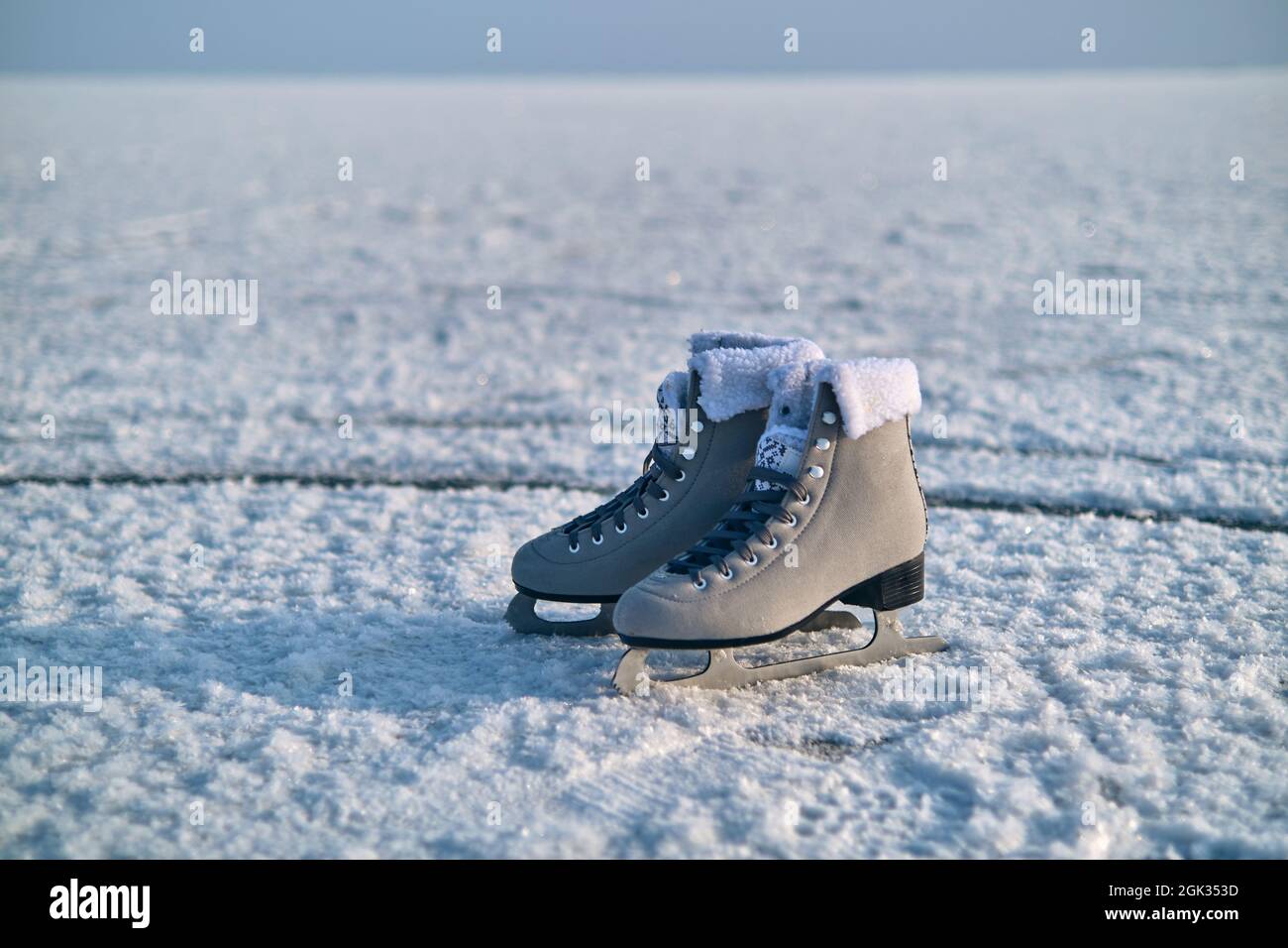 A pair of female figure skates stay on the ice Stock Photo