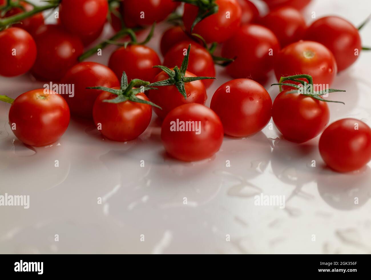 Group of cherry tomatoes on white table Stock Photo