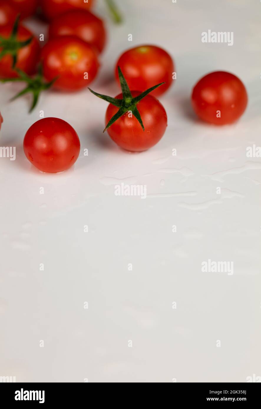 Group of cherry tomatoes on white table Stock Photo