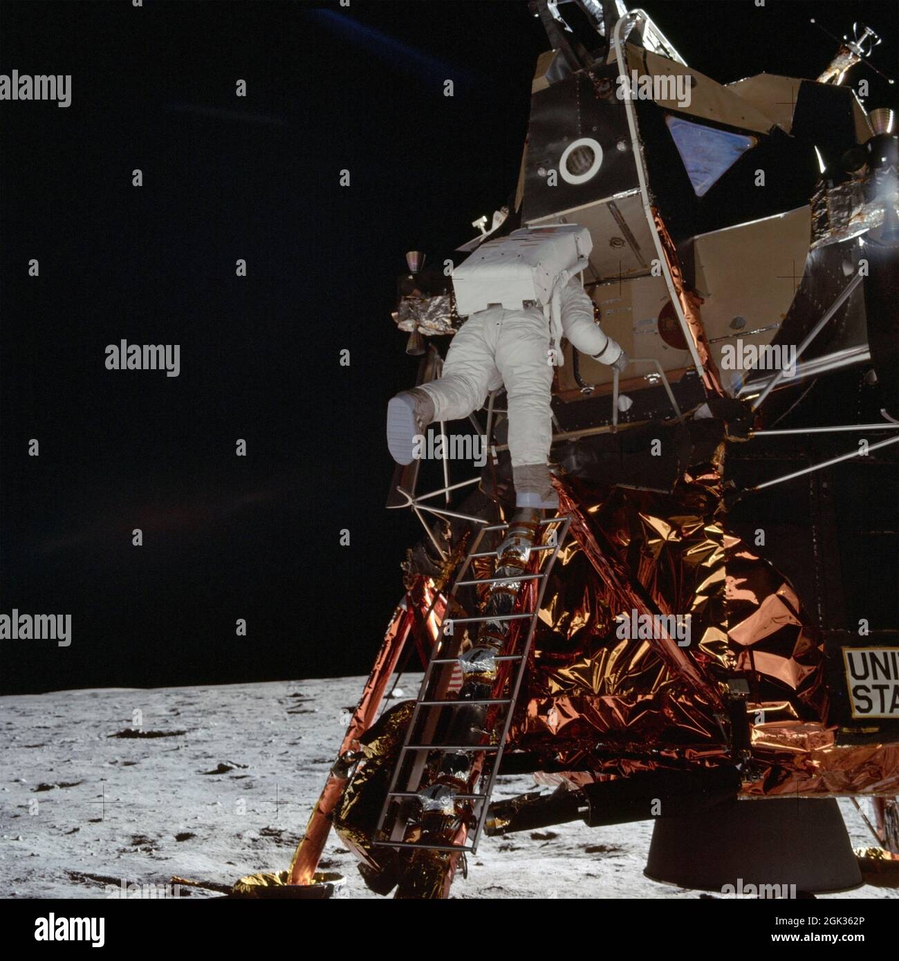 Astronaut Edwin E Aldrin Jr, Lunar Module (LM) pilot descends from the LM, climbing down the ladder. Lunar horizon visible in background.  Image taken at Tranquility Base during the Apollo 11 Mission. Original film magazine was labeled S.  Film Type: Ektachrome EF SO168 color film on a 2.7-mil Estar polyester base taken with a 60mm lens. Sun angle is Medium. Tilt direction is Northeast (NE). Stock Photo