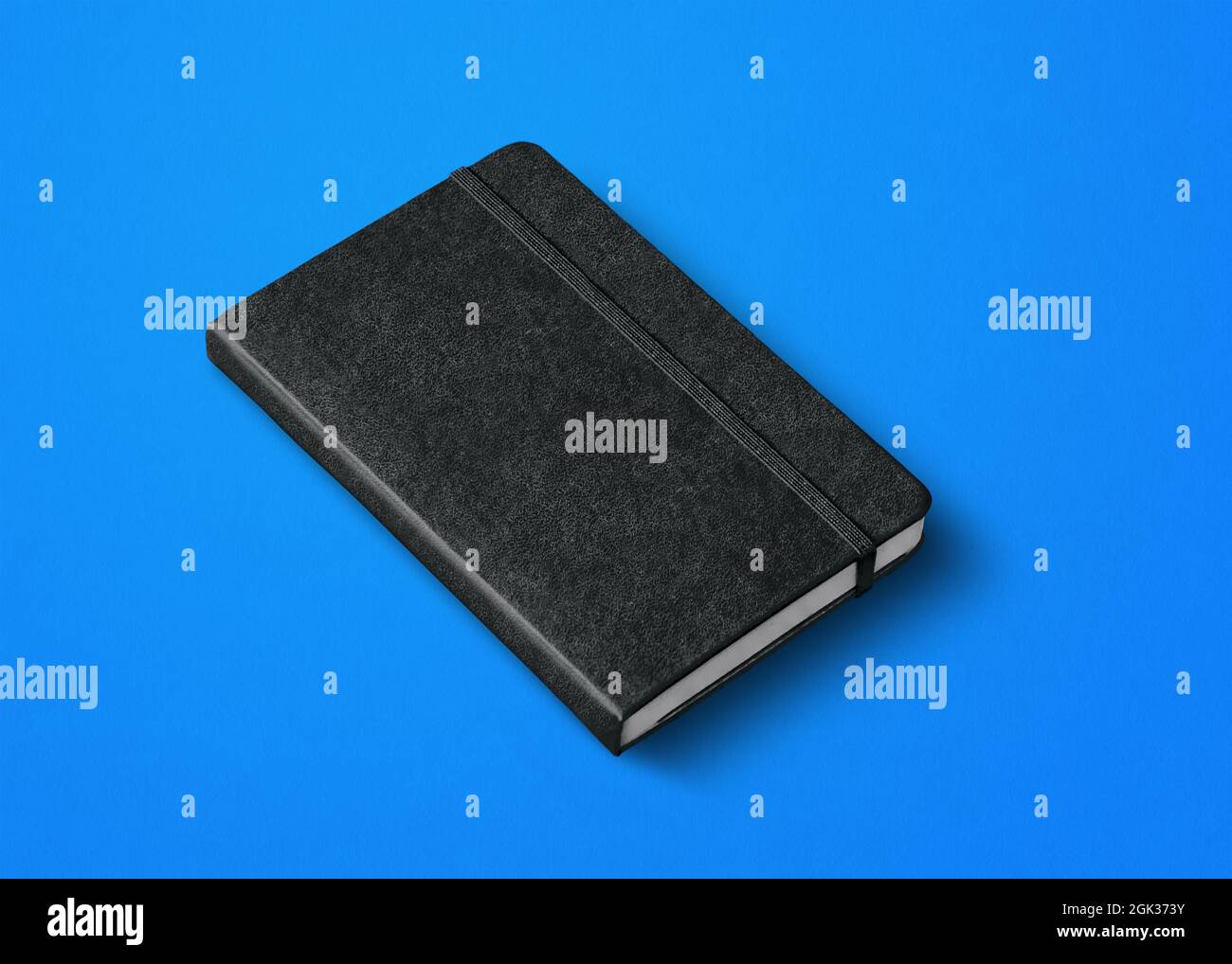 black closed notebook mockup isolated on blue Stock Photo