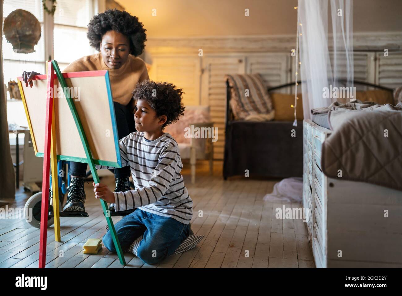 Happy child doing math exercises with her mother ot teacher together. Education people fun concept Stock Photo