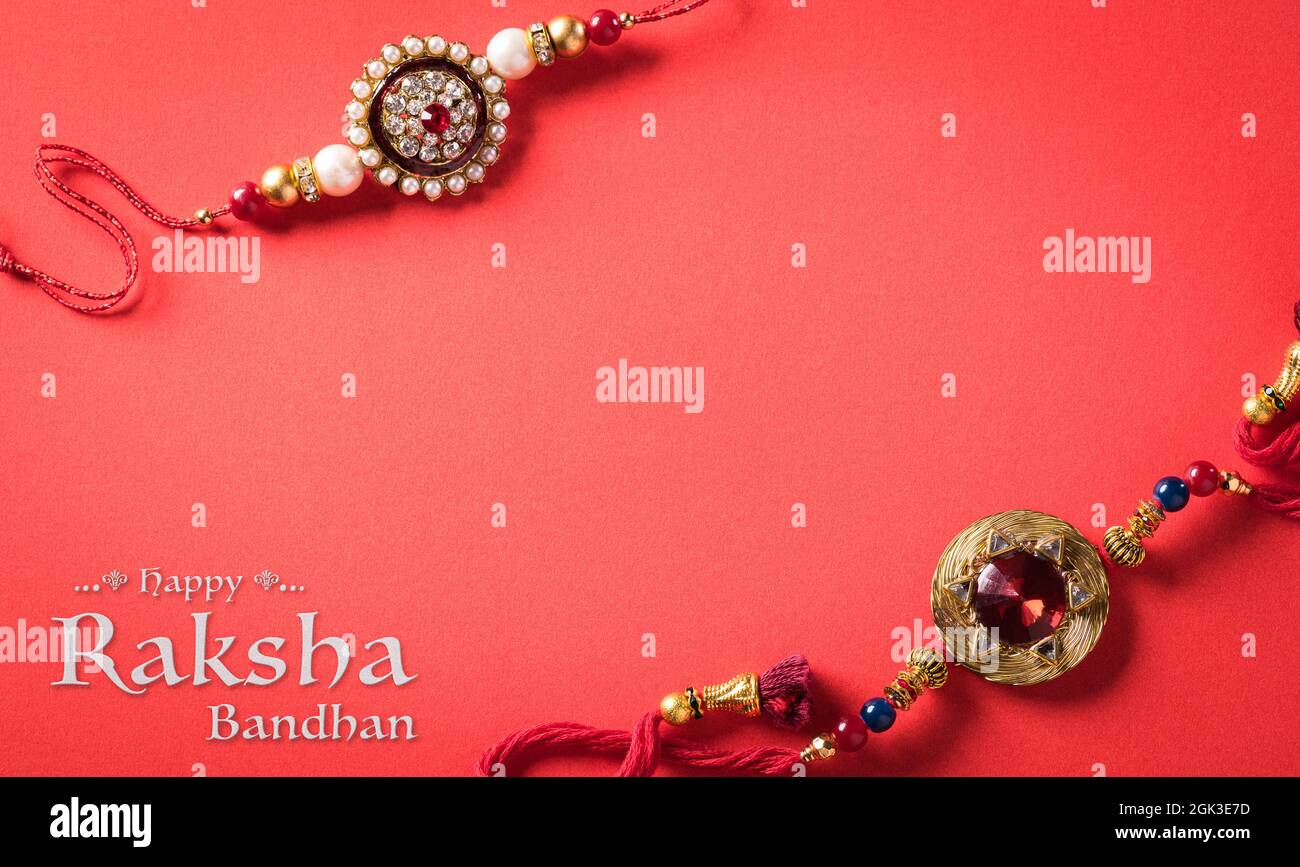 Raksha Bandhan, Indian festival with beautiful Rakhi on red background ...