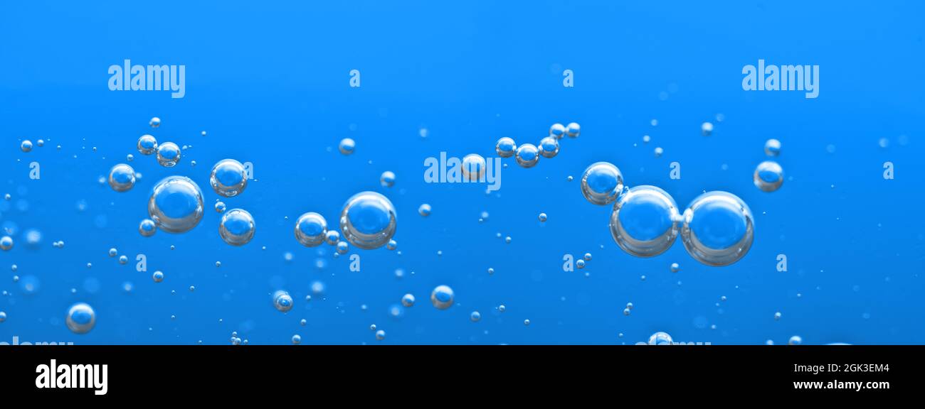 Oxygen bubbles float up in the liquid. Air bubbles under water. Clear