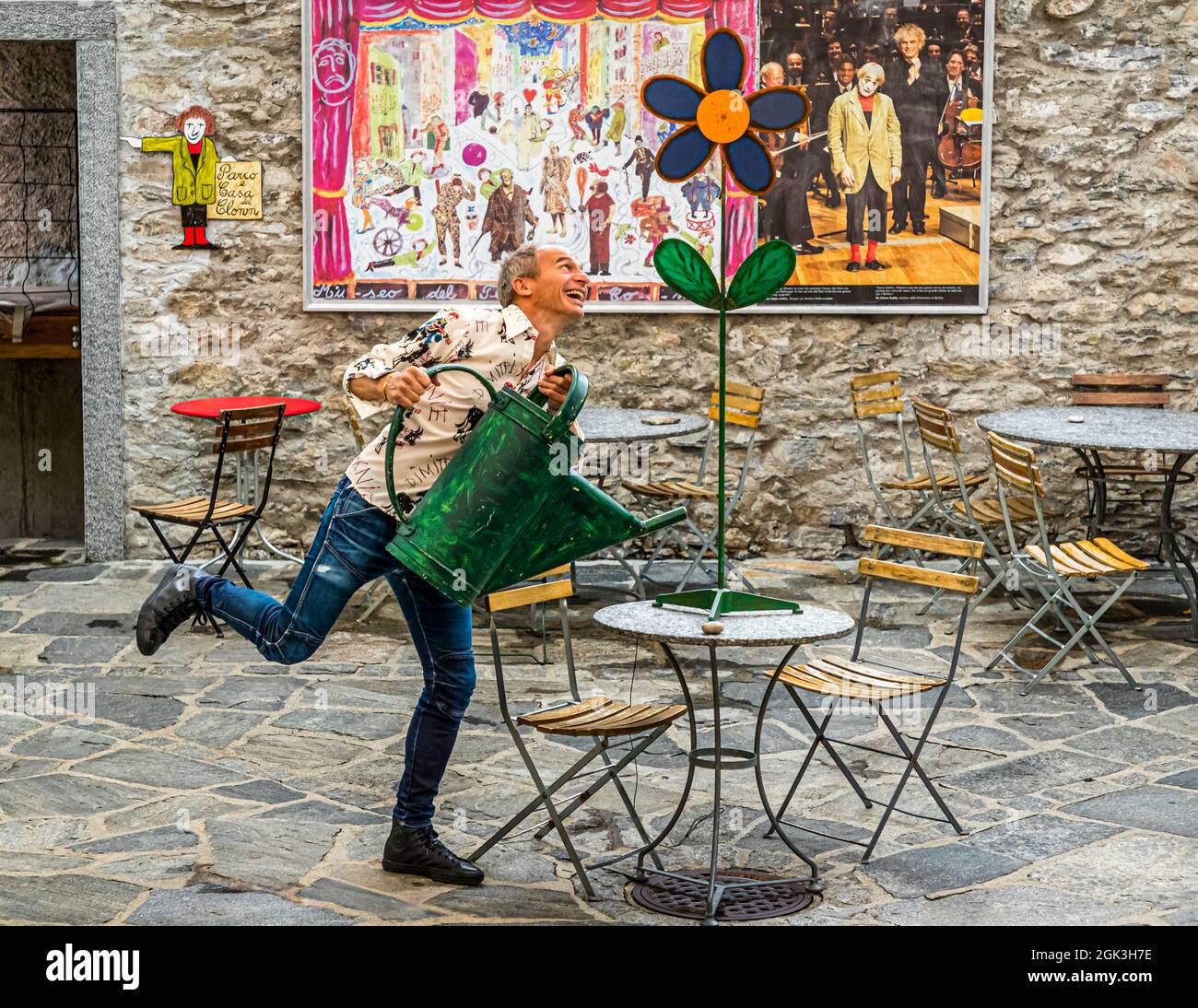 David Dimitri at the Museo Comico in front of the picture of his father the swiss clown Dimitri, Terre di Pedemonte, Verscio, Switzerland Stock Photo