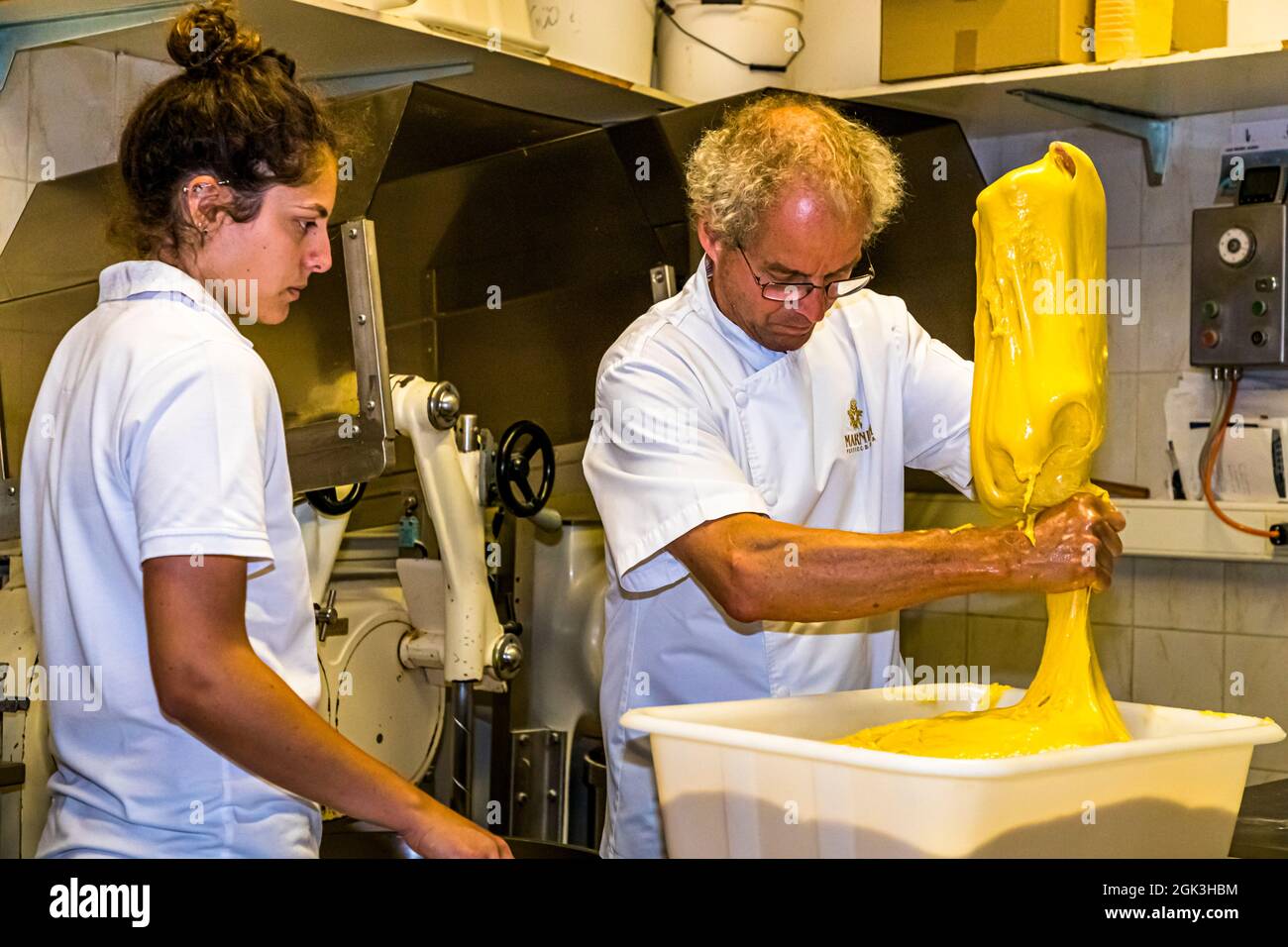 Panettone Prduction in the Pasticceria Marnin in Locarno, Switzerland. Circolo di Locarno, Switzerland. Arno Antognini with his daughter Naomi. Here, part of the pre-dough is weighed out. Because in the next step the main dough is enriched with different ingredients Stock Photo