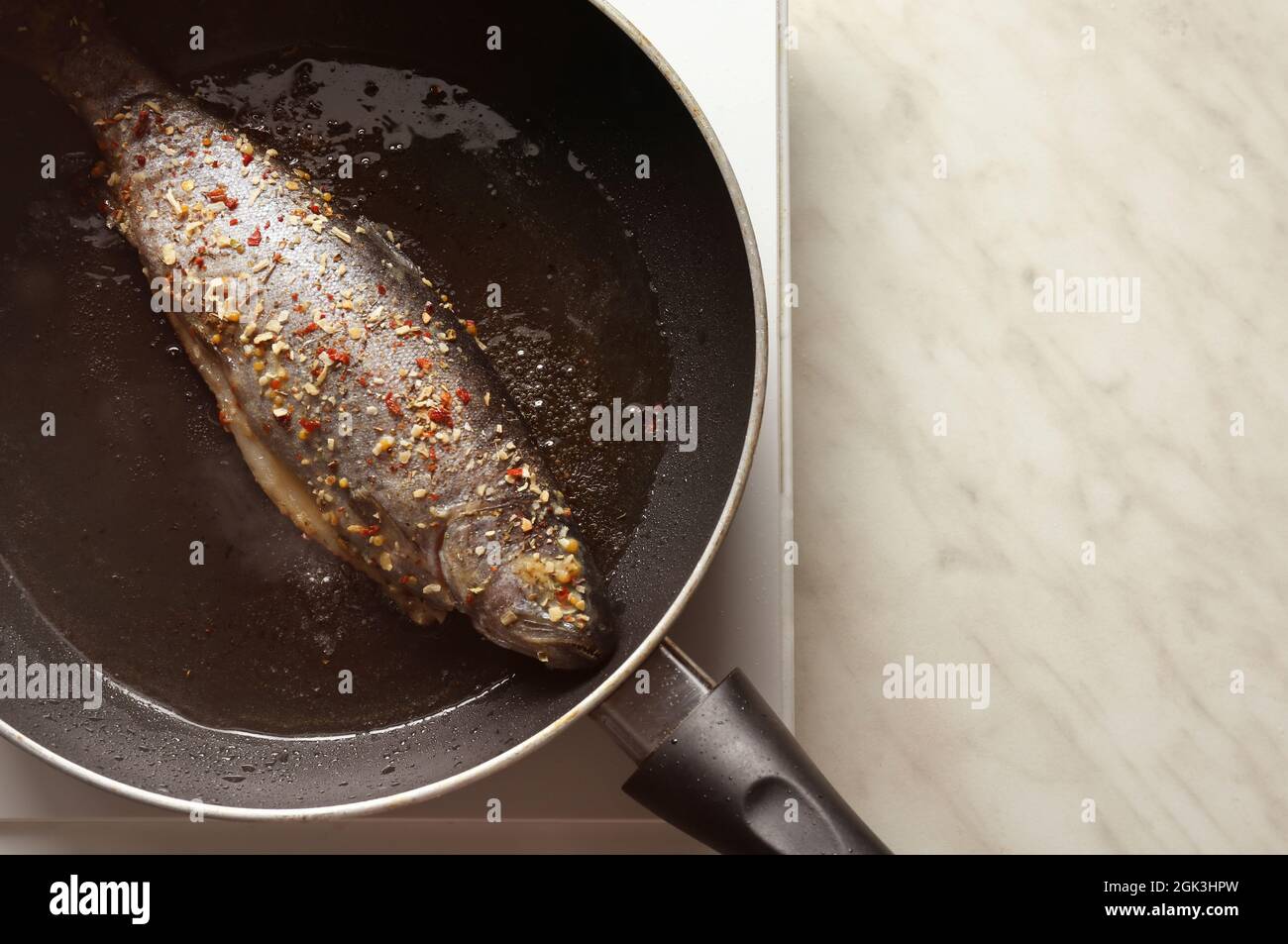 Cooking trout fish on frying pan Stock Photo Alamy