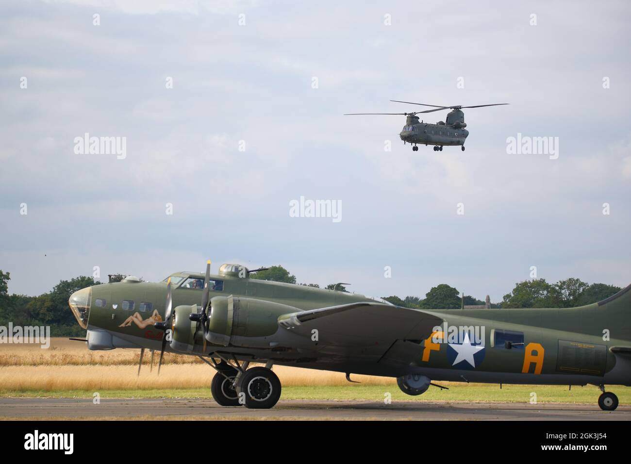 A Bell CH-47 Chinook flying over the Boeing B-17 'Sally B' at the Abingdon Air & Country Show 2021 Stock Photo