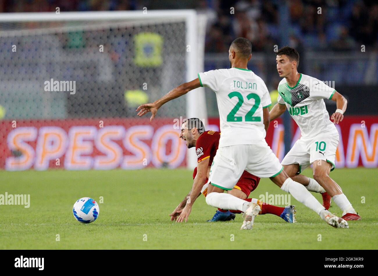 Rome, Italy. 12th Sep, 2021. Henrikh Mkhitaryan, of AS Roma, left, is challenged by Jeremy Toljan, center, and Filip Djuricic, of Sassuolo, during the Serie A soccer match between Roma and Sassuolo at the Olympic Stadium. Roma won 2-1. Credit: Stefano Massimo/Alamy Live News Stock Photo