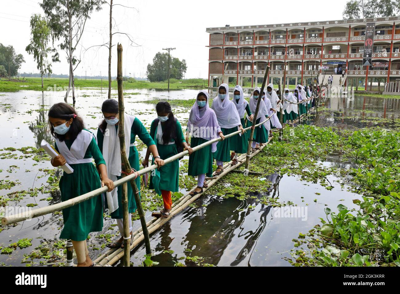 Students Coming Out From The School Walking On The Bamboo Bridge As The School Area Affected By Flood Waterafter Several Months All Schools And Colleges In The Country Begin Reopen On September