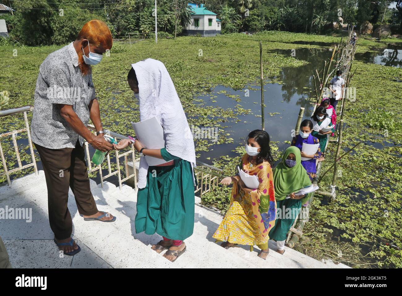 Students Coming Out From The School Walking On The Bamboo Bridge As The School Area Affected By Flood Waterafter Several Months All Schools And Colleges In The Country Begin Reopen On September