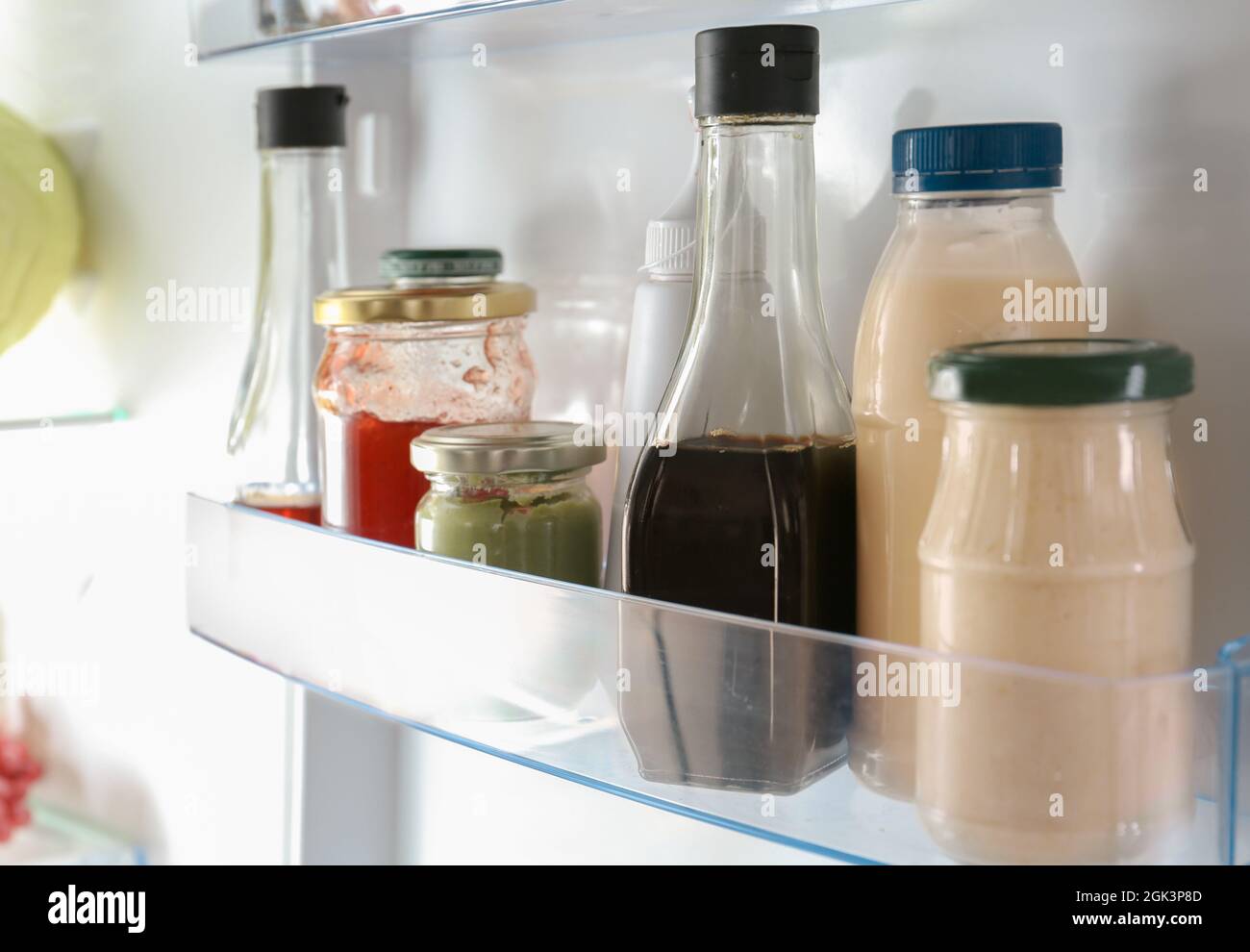 Different sauces on shelf in fridge Stock Photo Alamy