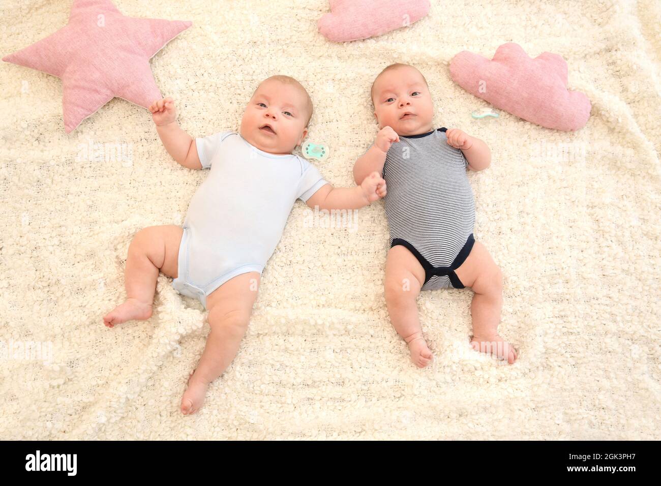 Cute little babies lying on bed at home Stock Photo Alamy