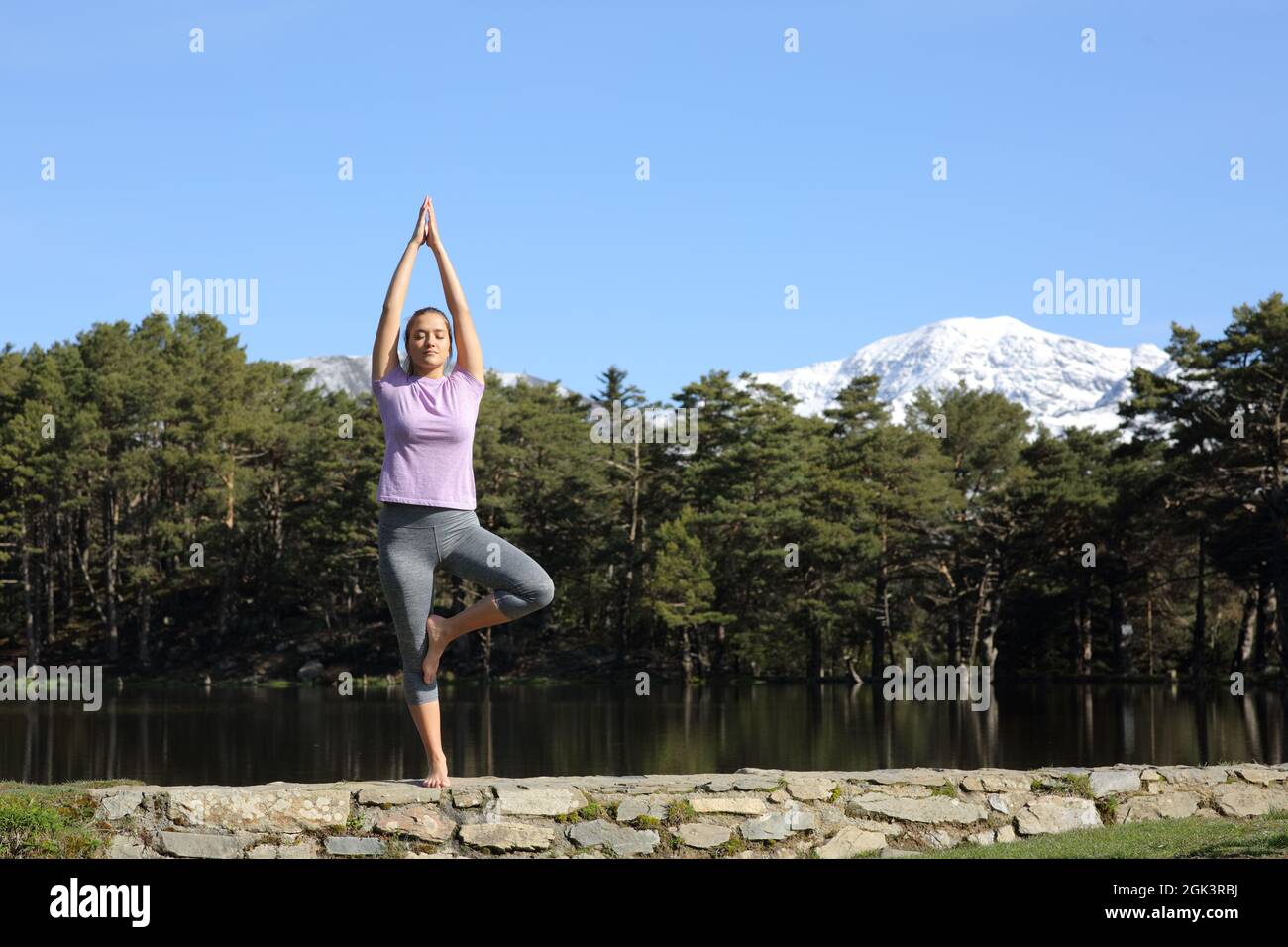 Portrait of adult Yoga teacher practicing advanced yoga standing