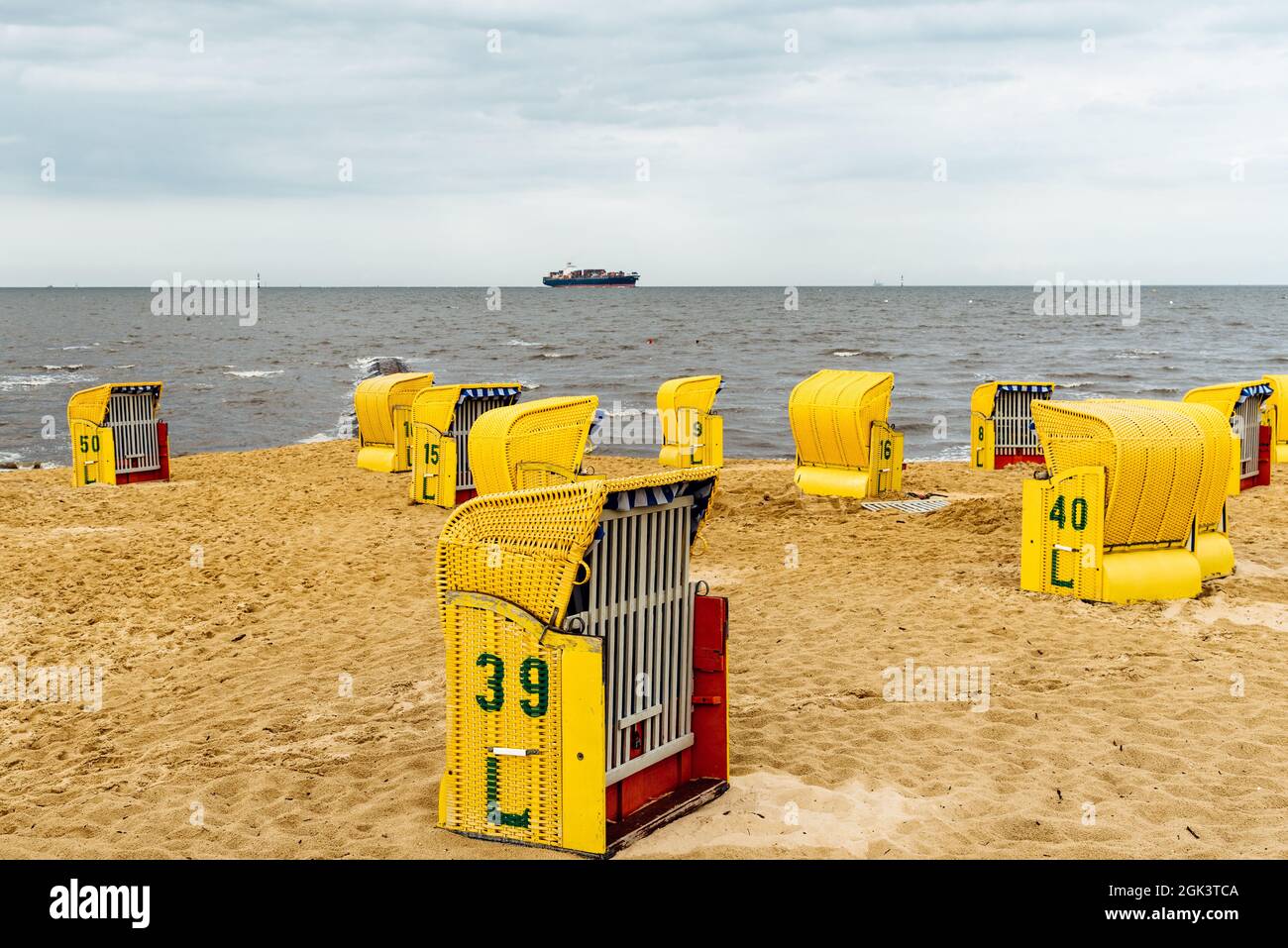 Closeup shot of yellow bamboo boxes with numbers on the beach of