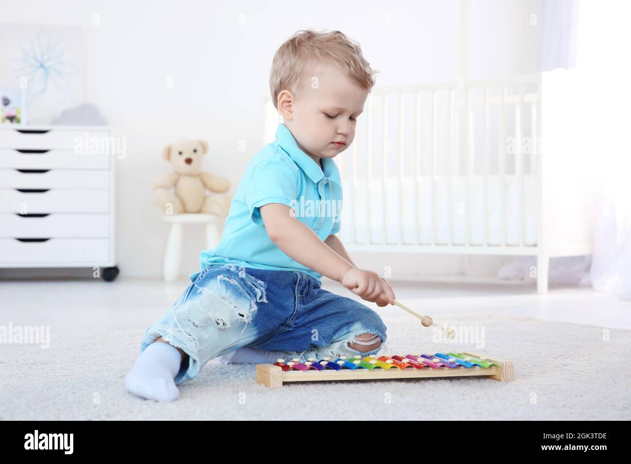 Cute little boy with xylophone at home Stock Photo Alamy