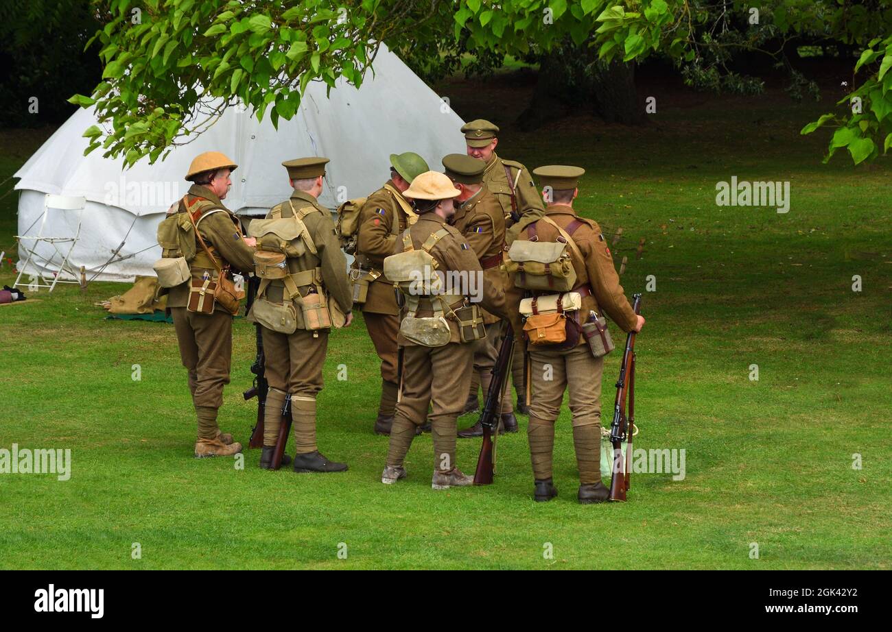 Men in World War One uniforms  with rifles in camp. Stock Photo