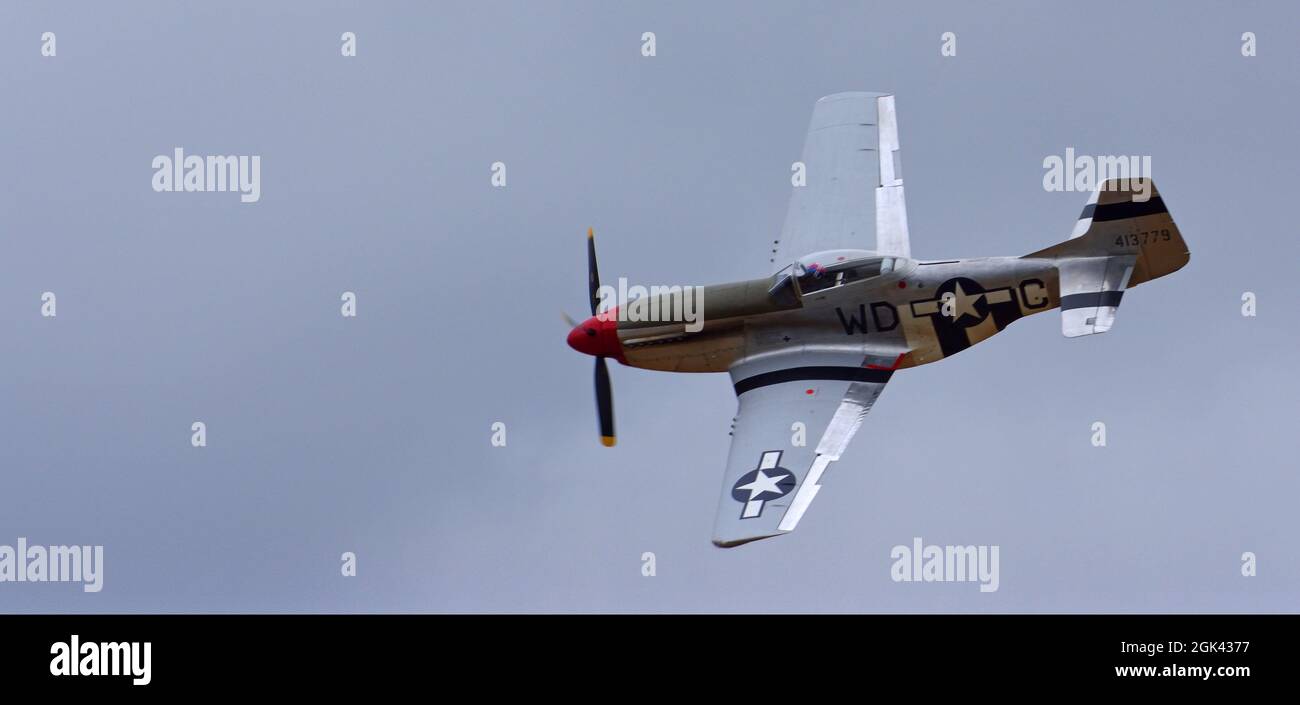 Classic  North American P-51D  Mustang WW2 fighter  aircraft in flight. Stock Photo