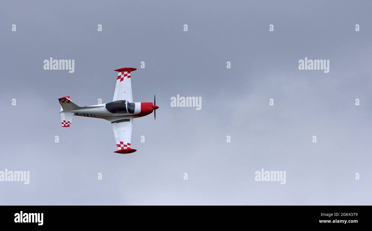 Classic  Siai - Marchetti F.260 G-RAZI  aircraft in flight with cloudy sky. Stock Photo