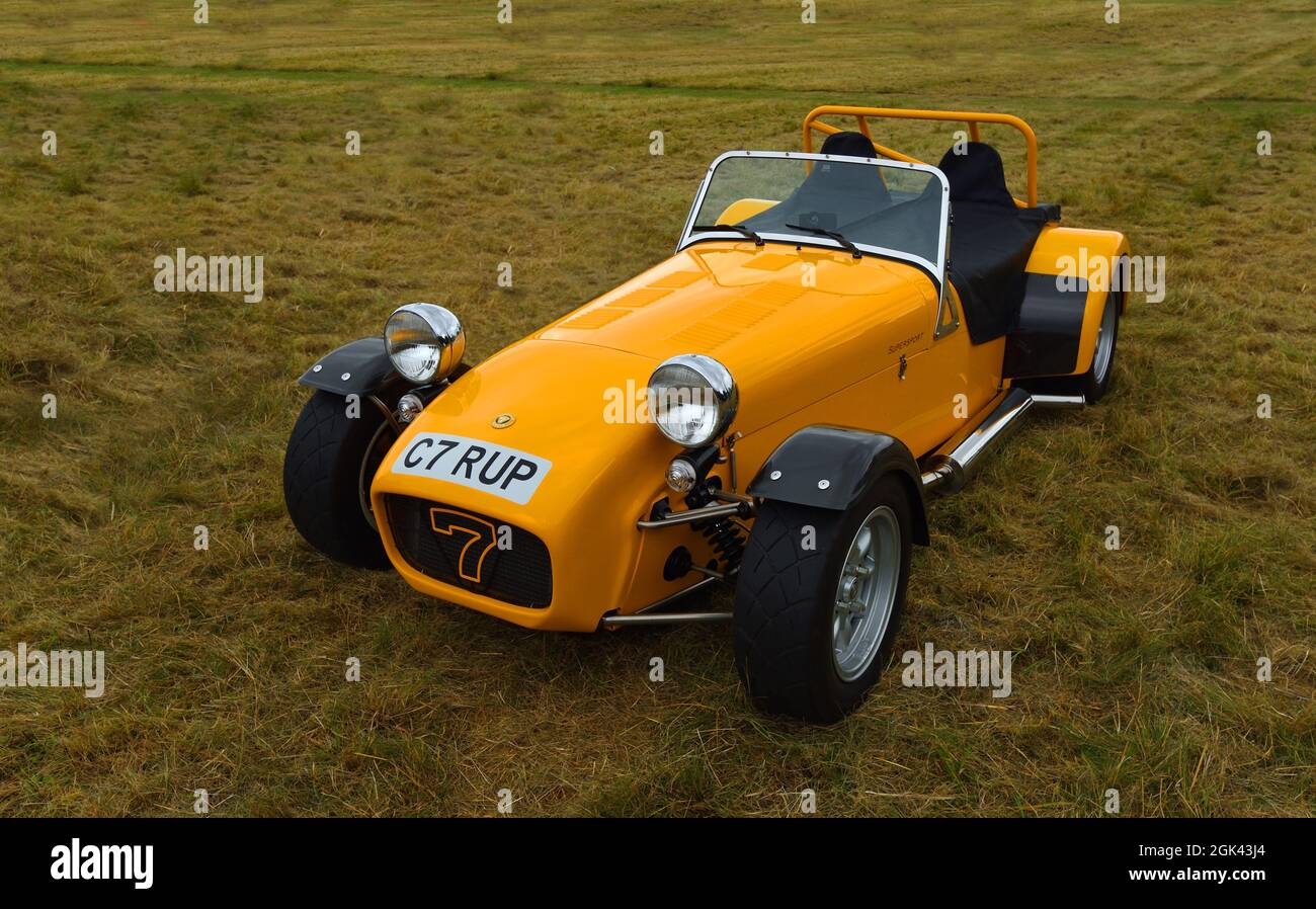 Iconic  Yellow Caterham C7  Car isolated on grass. Stock Photo