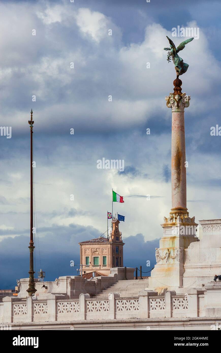 Italian Nation and Republic. View of the Altar of Nation and Quirinal Hill tower with national flag in Rome Stock Photo
