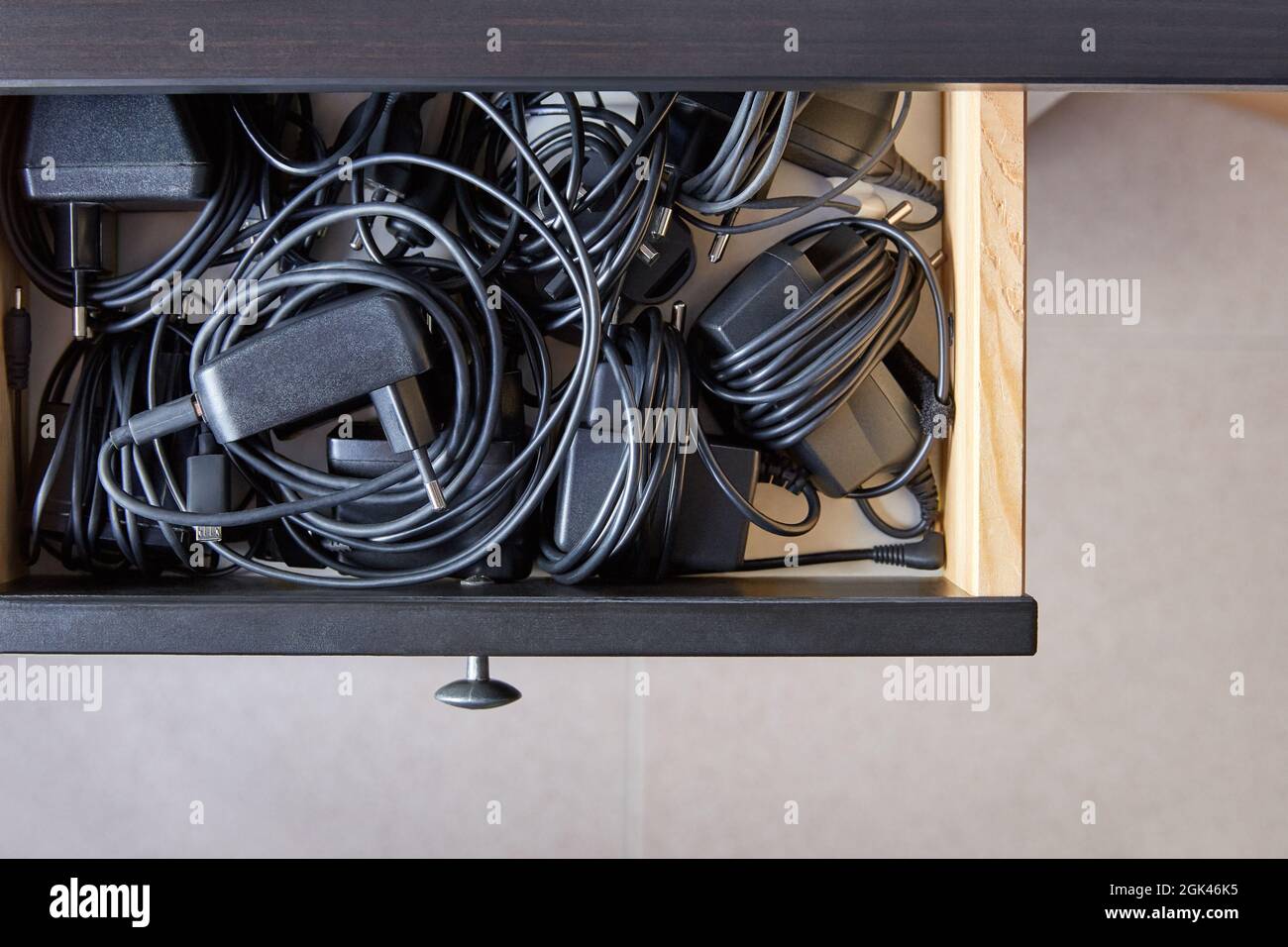 Overhead shot of drawer full of electronics wired chargers Stock Photo ...