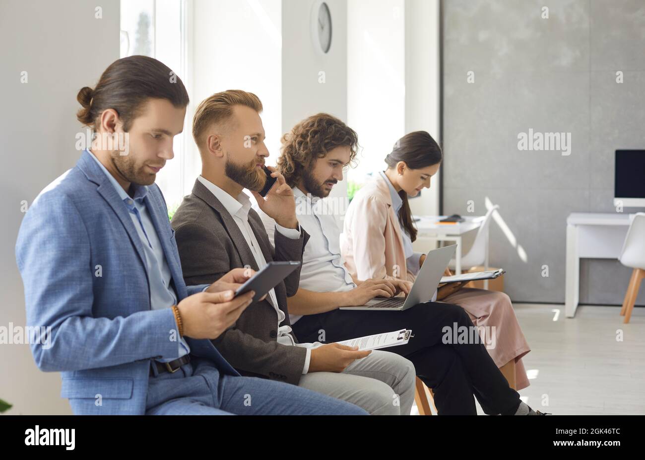 Group of young people waiting in line for a job interview or business appointment Stock Photo