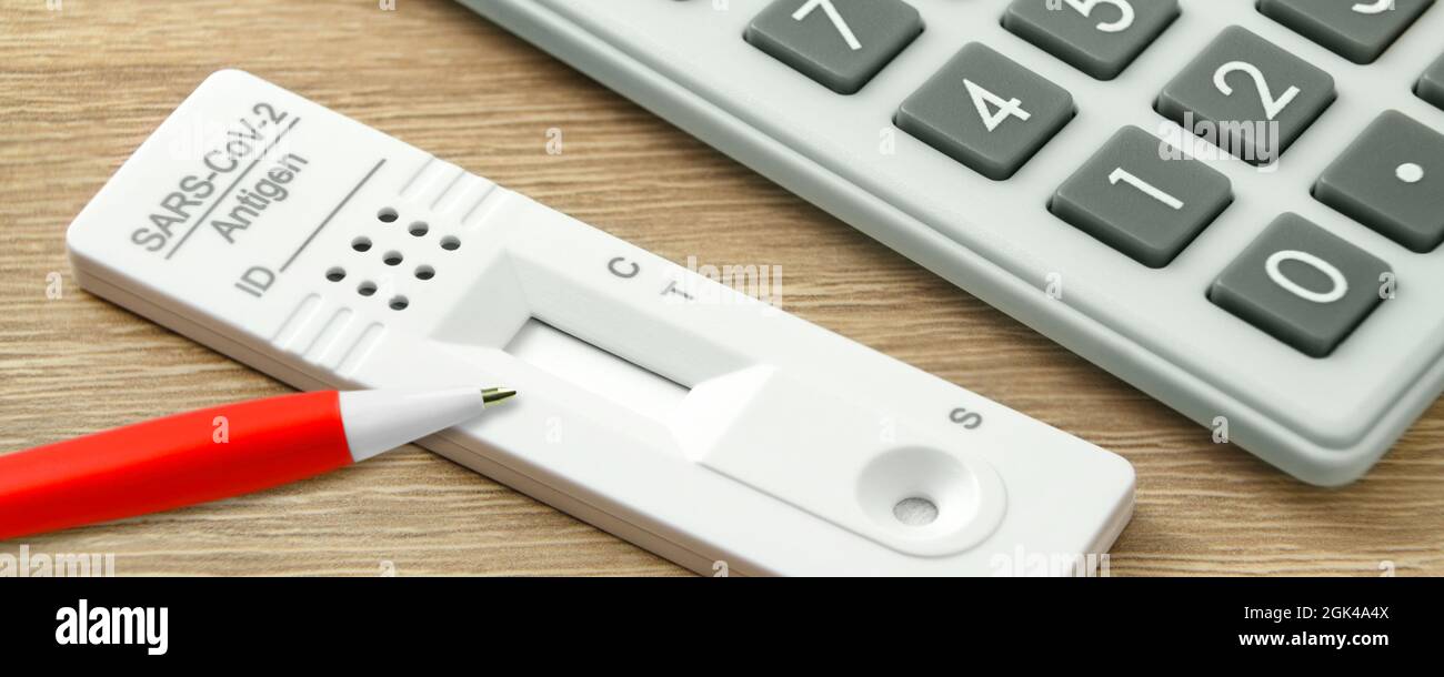 Calculator and Corona Rapid Antigen Test with red pencil Stock Photo