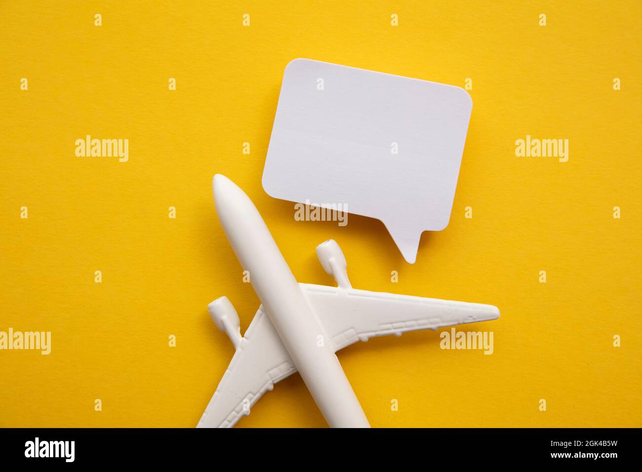 Airplane with a blank speech bubble. Flight feedback and holiday communication background Stock Photo