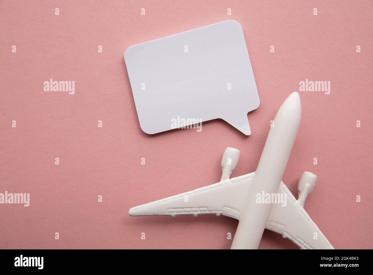 Airplane with a blank speech bubble. Flight feedback and holiday communication background Stock Photo