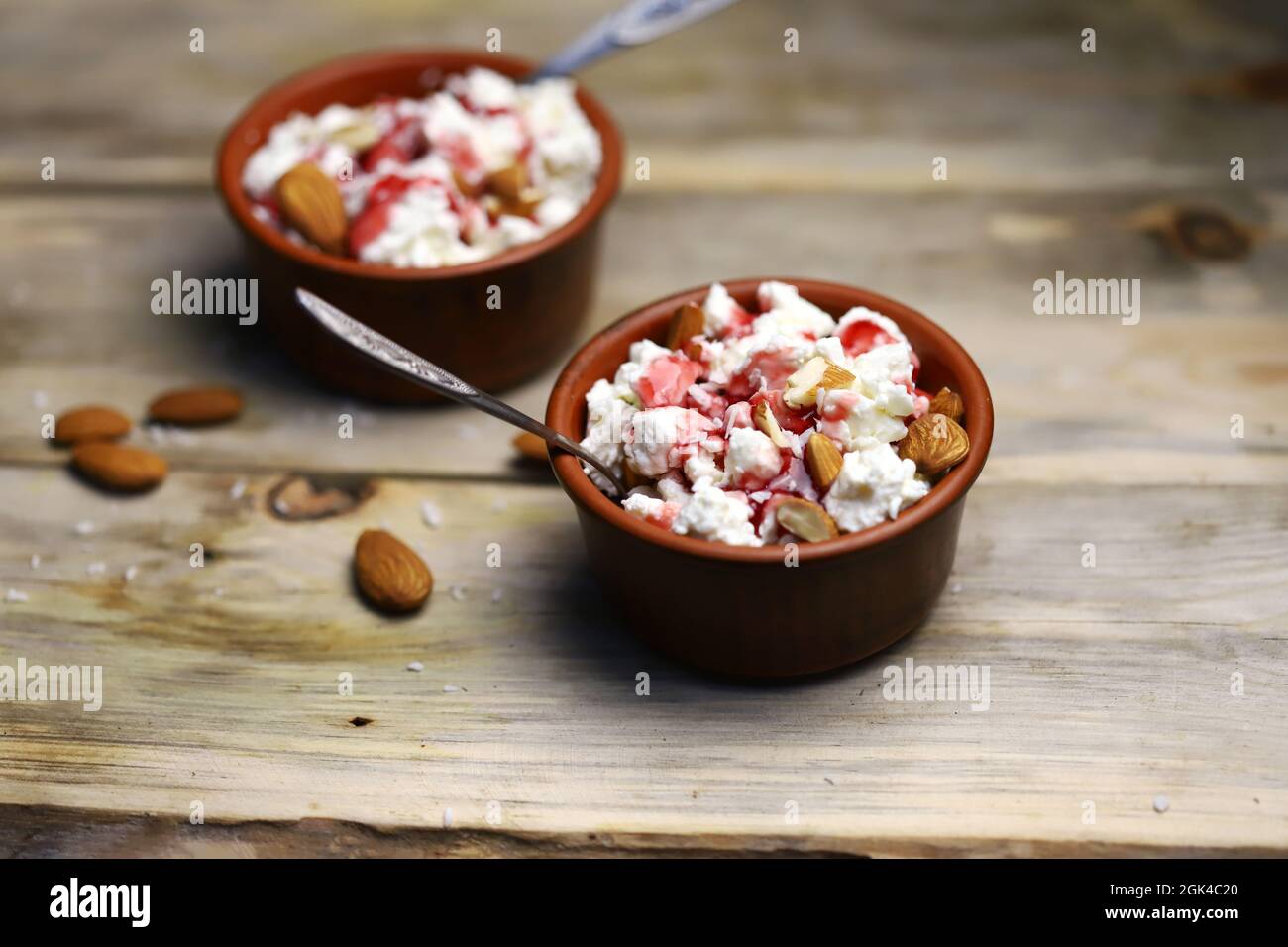 A bowl of cottage cheese with topping and almonds. Healthy food concept. Diet lunch or breakfast. The keto diet. Stock Photo