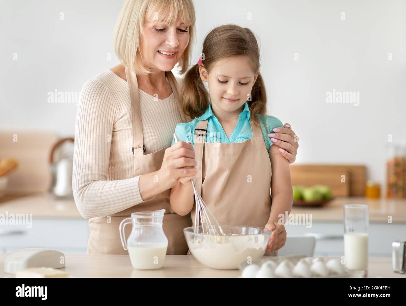 Happy senior lady and her granddaughter kneading dough Stock Photo - Alamy