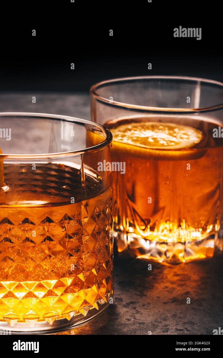https://c8.alamy.com/comp/2GK4G2X/alcohol-drink-in-two-rock-glasses-scotch-whiskey-rum-bourbon-liquor-or-brandy-cocktails-on-the-menu-vertical-dark-design-with-space-for-text-2GK4G2X.jpg