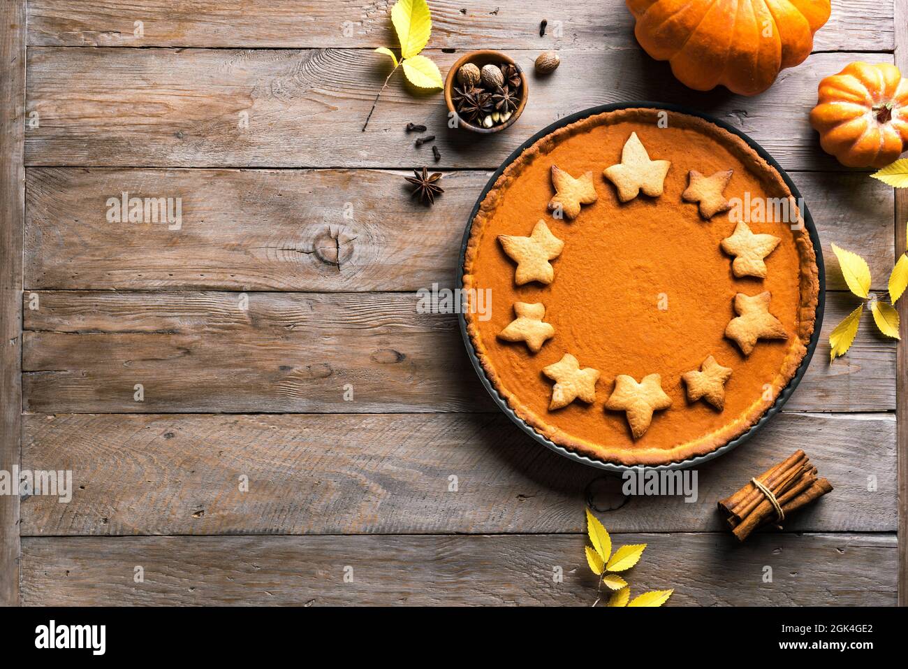 Pumpkin Pie on wooden background, top view, copy space. Homemade pastry for Thanksgiving holiday - traditional autumn  Pumpkin Pie or tart. Stock Photo