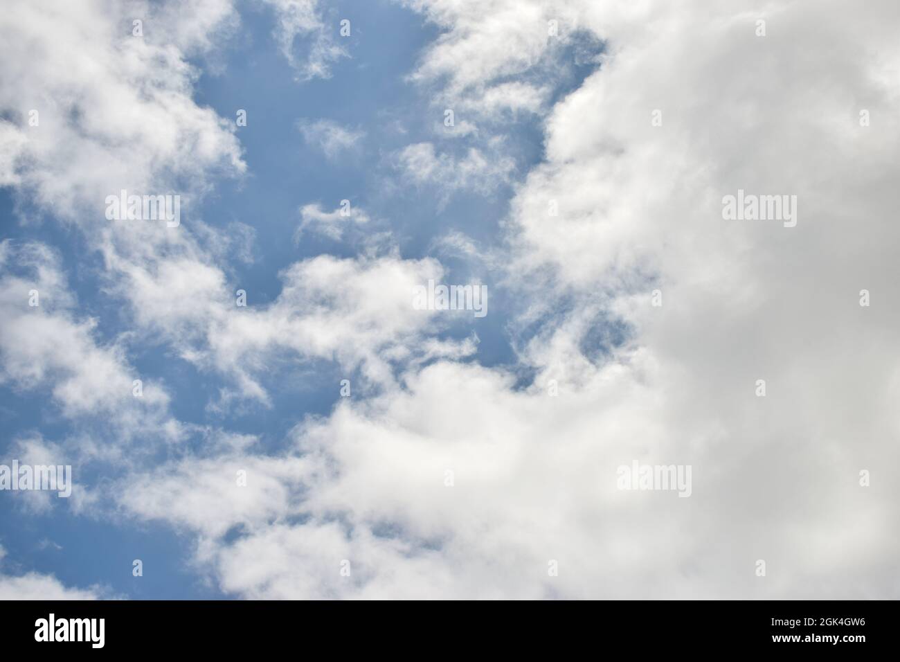 Blue Sky, white puffy cumulus clouds cloud, skies, meteorology, weather background Stock Photo