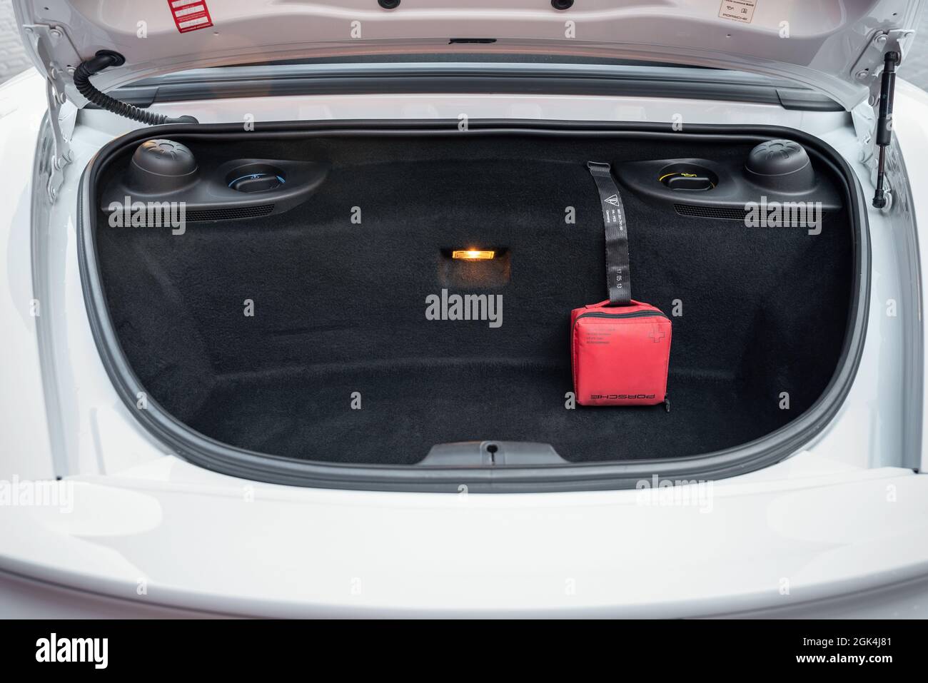 Open trunk of the car Porsche Boxster close up. Car first aid kit in