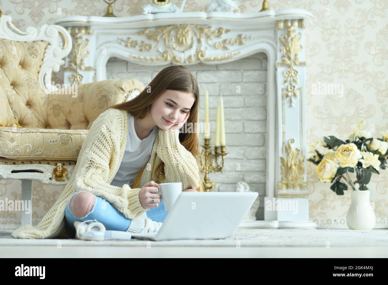 Beautiful teen girl sitting on floor near vintage armchair Stock Photo ...